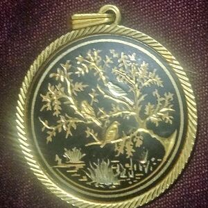 Elegant Gold and Black Bird Pendant